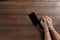 Close-up, hands of a man tied with a cord to the smartphone. The concept depends on technology, phone, social networks, a blogger