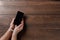 Close-up, hands of a man tied with a cord to the smartphone. The concept depends on technology, phone, social networks, a blogger