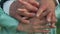 Close-up hands of married Caucasian adult couple standing outdoors hugging. Unrecognizable elegant man and woman
