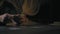 Close-Up Hands of Men Lay Out Playing Cards on a Wooden Table at Night in the Lantern Light