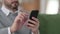 Close up of Hands of Middle Aged Man using Smartphone