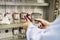 Close-up of hands with multimeter in electrical control panel. Engineer tests electrical automation box