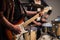 Close-up of the hands of a musician playing an electric solo guitar in the Studio.