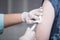Close-up hands,nurses are vaccinations to patients using the syringe.Doctor vaccinating women in hospital.Are treated by the use