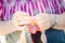 Close up of Hands of an old lady knitting on knitting needles, using colorful wool