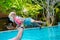 Close-up. Hands out of the water in which a small child is having fun. Summer holiday in the pool. An eight month old baby laughs