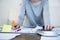 Close up hands with pen of woman suffering stress doing domestic accounting paperwork bills