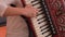 Close up on hands playing accordion