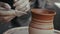 Close-up, Hands of the Potter Woman Cut the Pattern on the Clay Pitcher Rotating on the Pottery Circle