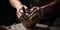 Close up of hands on a potters wheel forming a vase