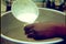 Close-up of hands pouring milk from ladle to plastic cup and handing out bread