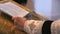 Close-up of hands of priest reading the holy bible