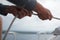 Close up of hands pulling a rope, sheet on a sailboat