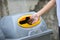 Close up of hands putting water bottles in recycling bin