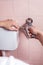 Close-up of a hands repairing toilet