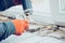 Close up of hands of repairman, professional builder working indoors, installs window