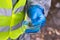 Close - up of the hands of the scientist in protective gloves, which hold a Petri dish with a plant, for the test