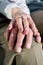 Close-up hands of senior couple resting on knee