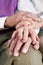 Close-up hands of senior couple resting on knee