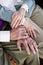 Close-up hands of senior couple resting on knees