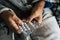 Close up of hands of senior man taking or choosing a pillow to cure his fever and to be healthy and not sick - pensioner and