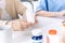 Close up hands of a senior woman holding a medical bottle and asking for information from the nurse before administering