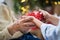 Close-up of hands of senior and young woman holding a present at Christmas.