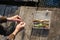 Close up of hands setting lure as bait. He is working on raft while floating over river. Box with hooks is in background