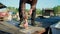 Close up of hands setting lure as bait. He is working on raft while floating over river. Box with hooks is in background