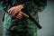 Close up of hands soldier holding a gun in gray background