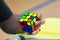 Close-up of hands solving a Rubik`s Cube. Color puzzle.