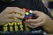 Close-up of hands solving a Rubik`s Cube. Color puzzle.