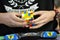 Close-up of hands solving a Rubik`s Cube. Color puzzle.