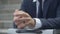 Close-up hands of stressed nervous businessman sitting outdoors. Palms of unrecognizable Caucasian man in formal
