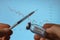 Close-up in the hands of a syringe and a vial of Omicron vaccine against the background of the stock market chart. A new