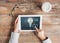 Close up of hands with tablet pc and lighting bulb