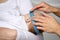 Close up of hands with tape measuring baby head