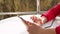 Close-up of hands, teenager girl uses smartphone,on open balcony. spring sunny day.