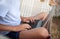 Close up hands teenager man workes on a laptop is sitting in hammock. Boy on summer vacation in nature. Concept distant work,