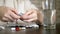 Close up of hands touching pills. The concept of health care, vitamin deficiency. woman sorts pills sitting at the table