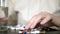 Close up of hands touching pills. The concept of health care, vitamin deficiency. woman sorts pills sitting at the table