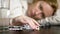 Close up of hands touching pills. The concept of health care, vitamin deficiency. woman sorts pills sitting at the table