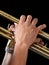 Close-up of the hands of a trumpet player holding his instrument