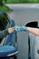 Close up of hands of two car drivers wearing protective gloves, making fist bump while greeting each other on the road