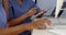 Close up hands of two doctors working with computers