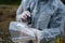 Close up on hands of unknown man forensic police investigator collecting evidence in the plastic bag at the crime scene