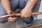 Close up on hands of unknown worker plumber cutting central heating copper pipes