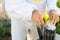 Close-up of hands of unrecognizable beekeeper fills the bee smoker with small woods.