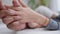 Close-up hands of unrecognizable couple stroking palms. Young loving Caucasian woman and African American man caressing