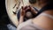 Close-up hands of unrecognizable female potter making ceramic pot on twisted pottery wheel in pottery workshop, top view